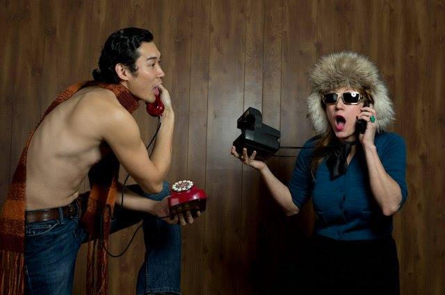 Image of Trevor in a scarf with a red phone to his ear and woman in a fuzzy hat holding a Polaroid camera and a phone to her ear.